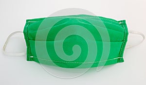 Green medical face mask on a white background