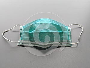 Green Medical mask to protect from bacteria, virus, sneeze, cough, and pollution.