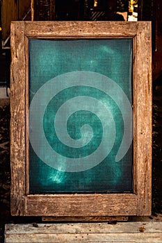 Green menu chalkboard with wooden frame for restaurant or shop