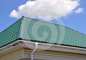 Green Meta Tiles Roof and Rain Gutter System with Downspout Pipe House Exterior