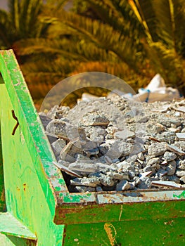 Metal container with construction waste rubble