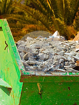 Metal container with construction waste rubble