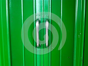 green metal doors and white door handles
