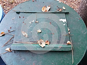 green metal garbage or trash can with closed door