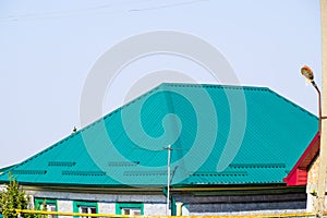 Green metal profile corrugated roofing on the