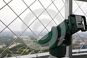 Green metal tower viewer on observation deck, closeup.