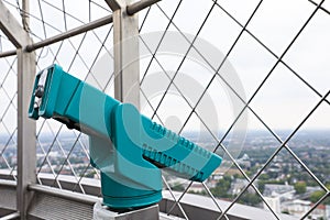 Green metal tower viewer on observation deck. Space for text