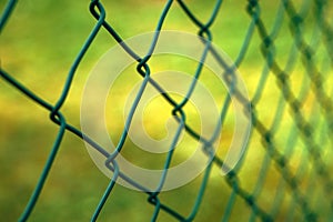 Green metallic chain link fence in perspective