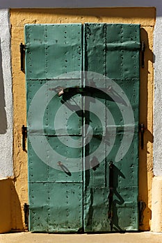 Green metallic door on a wall of the Unitarian Church in Rimetea, Alba County, Romania, Europe. photo