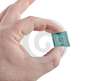 Green microchip in man hand on white background.