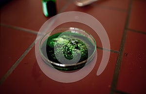 Green microscopic gel in glass in lab