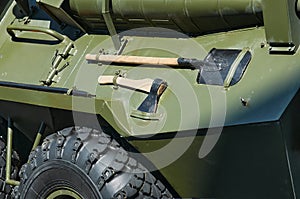 Green military camouflage khaki armored personnel carrier for the transport of manpower. A simple hand tool. Auxiliary