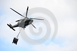 Green Military Helicopter Carrying a Jeep