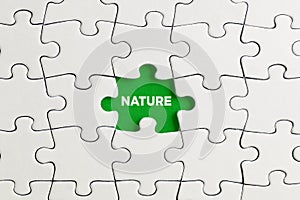 Green missing puzzle piece with the word nature. Environmentalism, destroying the nature