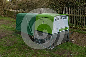 A green modern bright looking chicken coup or hen house with covered top