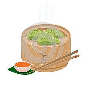Green momo dumplings in wooden steamer basket