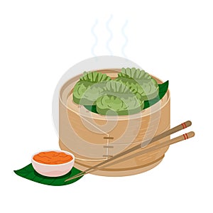 Green momo dumplings in wooden steamer basket