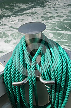 Green mooring ropes on board the boat