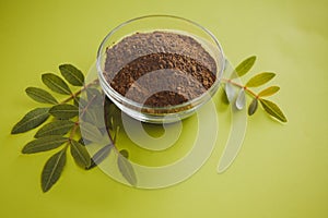 Green moringa leaf powder. Moringa leaf tea. green powder on white background