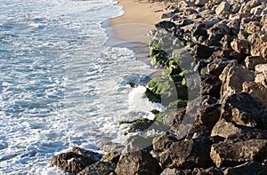 Green mossy rocks and Mediterranean waves