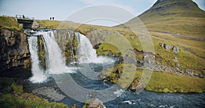 Green mountain peak and Kirkjufellsfoss fall is popular attractions at morning at Iceland, Summertime trip in iceland