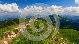 Green mountain ridge in nice weather, with blue sky and white clouds. Mala Fatra