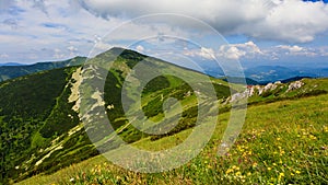 Green mountain ridge in nice weather, with blue sky and white clouds. Mala Fatra