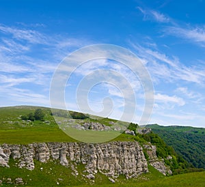 green mountain valley covered by grass under blue cloudy sky photo
