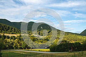 Green mountains shot against blue sky in evening sun.Hilly landscape.