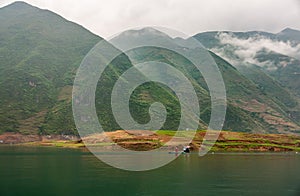 Green mountains under misty cloudscape along Daning River, Wuchan, China