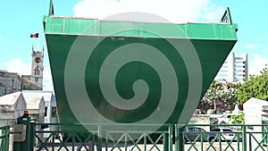 Green movable drawbridge captured while lifting in Bridgetown in Barbados.