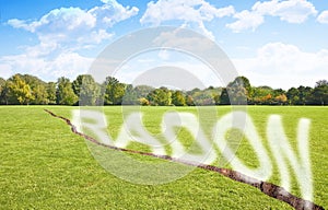 A green mowed lawn with a diagonal crack with radon gas escaping - concept image with copy space