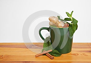 Green mug filled with natural herbal ingredients