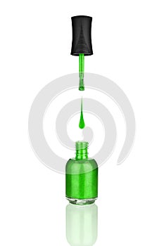 Green nail polish glass bottle, brush, drop on white background isolated close up, mirror reflection, green open varnish package