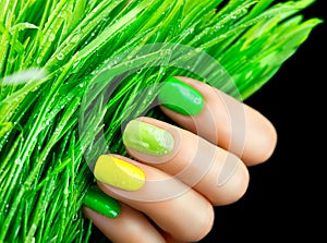 Green nails. Beautiful nailpolish with green grass photo