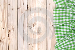 Green napkin cloth on wooden table, top view
