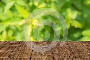 Green nature blur with wooden table background for natural products montage template