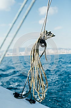 Green nautical rope inside pulley on boat