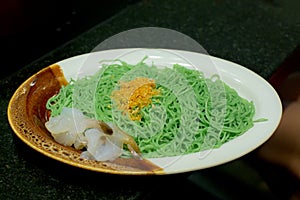 Green noodles on plate.