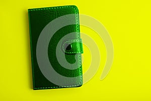 green notepad on a yelow background