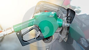 Green nozzle pump Gun petrol from oil pump in the car tank to refueling