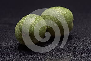 Green nuts with water drops