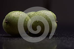 Green nuts with water drops