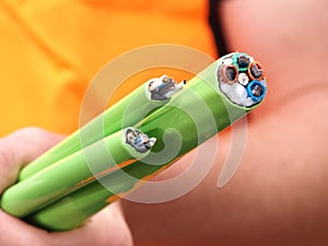Green Nylon jacketed fiber optic cables bundle hand held