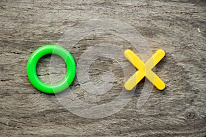 Green O and yellow X on wood background & x28;Concept for yes, no or approve or reject