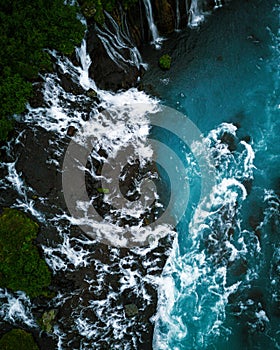 Green ocean water and rocky shoreline