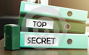 3 green office folders with text TOP SECRET