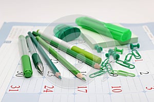 Green office supplies - pencils, pens, markers.