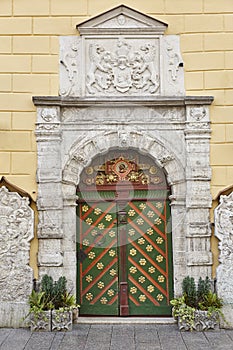 Green old fashioned wooden door on stone facade. Tallinn