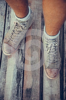 Green old vintage sneakers on a manâ€™s foot